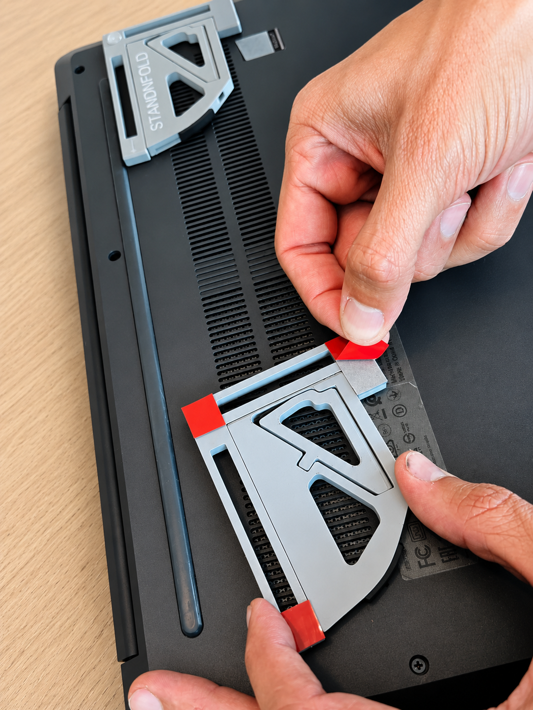 Peel adhesive and stick StandNFold onto laptop